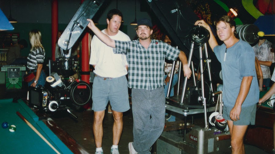 a group of men standing next to a machine