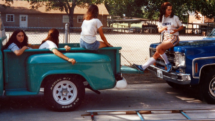 a group of girls in a pickup truck