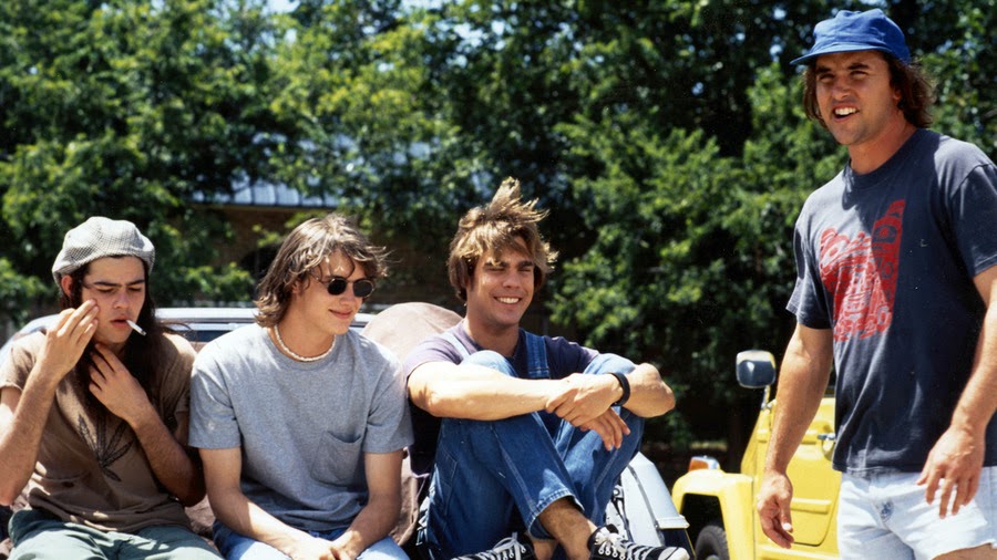 a group of men sitting on a car