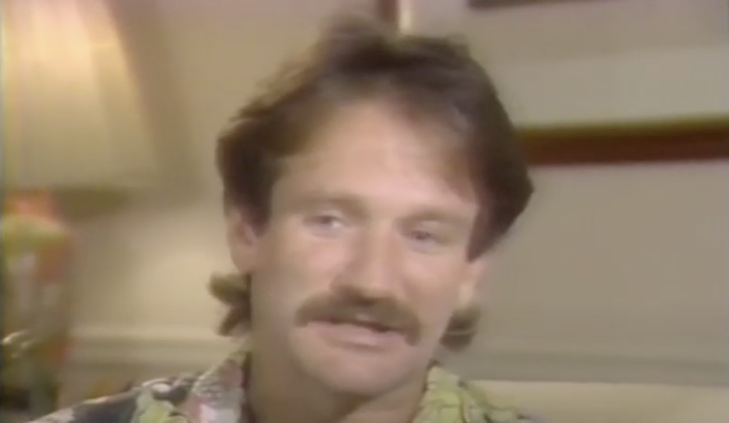 Young Robin Williams with a moustache