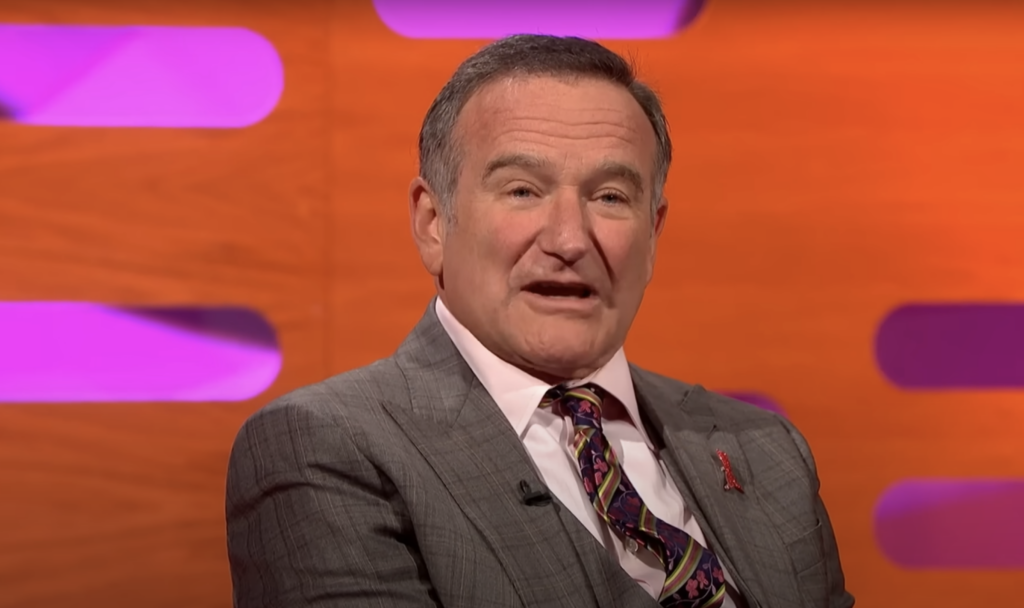 Robin Williams in a suit on a talk show