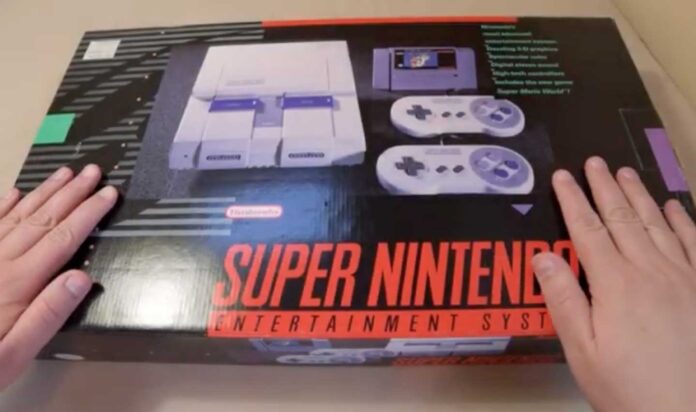 Super Nintendo Unboxing video screenshot that shows two hands on an original SNES from 1991