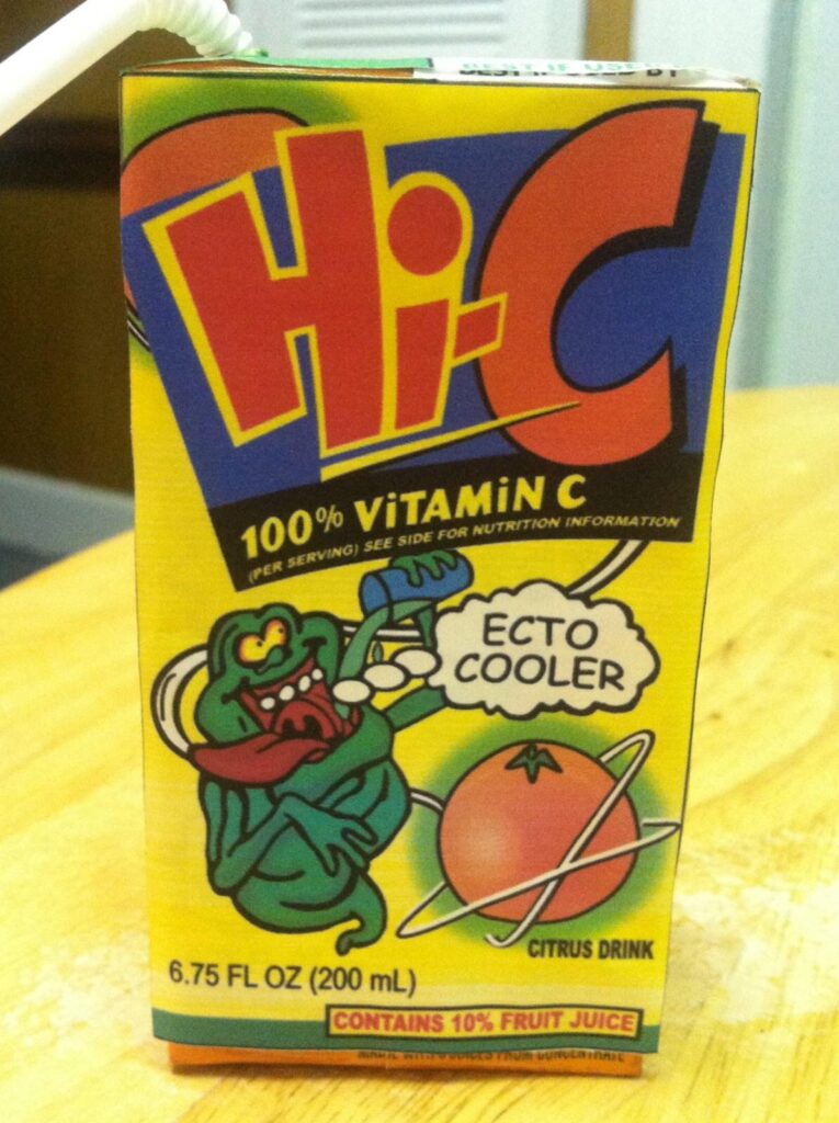 A box of Hi-C Ecto Cooler citrus drink showcasing a green cartoon ghost on the front, ideal for Ghostbusters collectibles enthusiasts. The packaging highlights 100% Vitamin C and contains 10% fruit juice. It is 6.75 fl oz (200 ml).