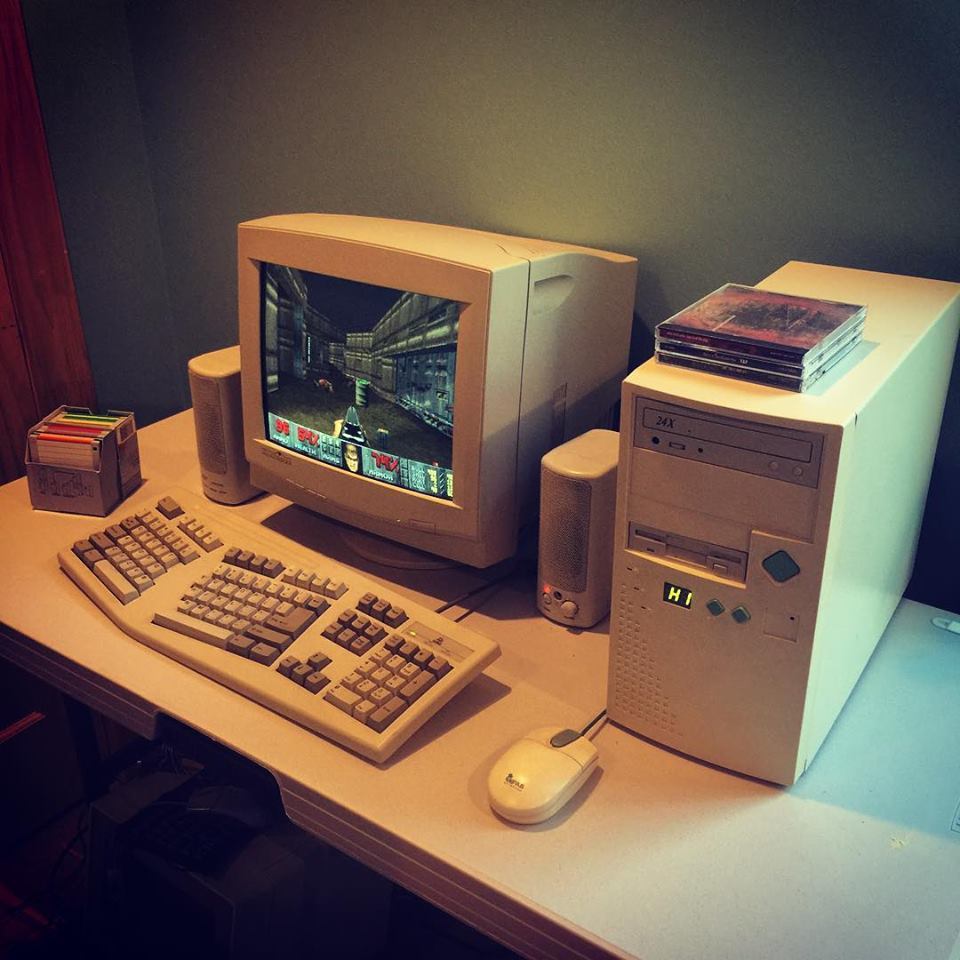 Old desktop computer with Doom on the screen