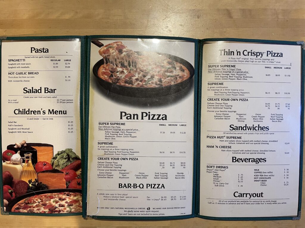 Discover a delightful Pizza Hut menu featuring various sections: Pasta, Salad Bar, Children's Menu, Pan Pizza, Thin n Crispy Pizza, Sandwiches, Beverages, and Carryout. Explore our diverse dish options in multiple sizes and price points for every taste.