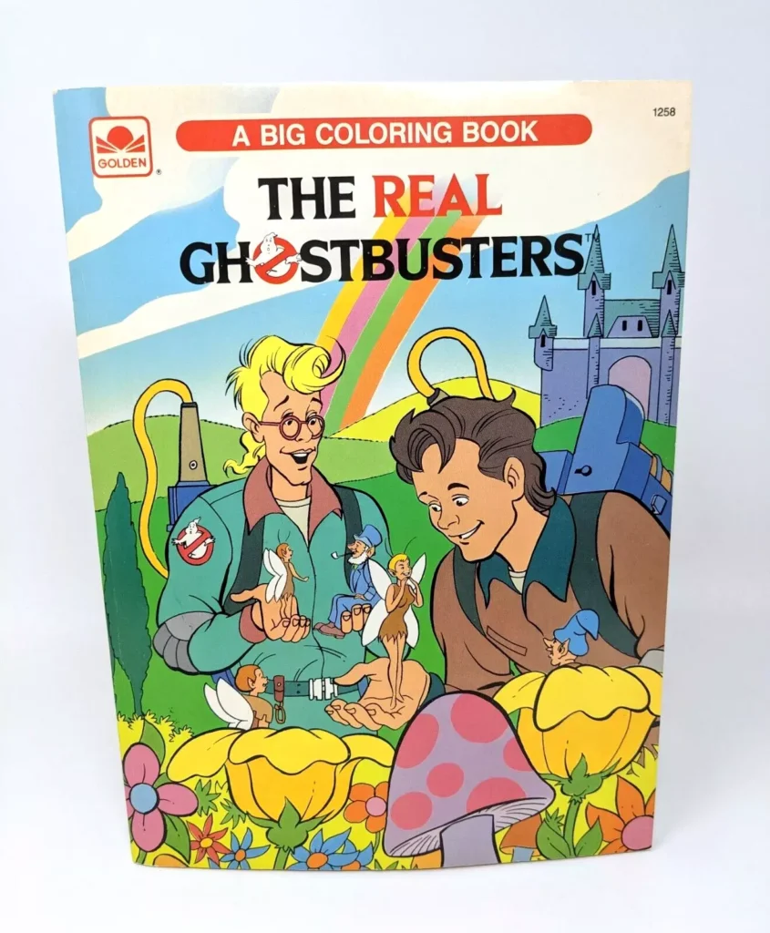 Cover of The Real Ghostbusters coloring book. Two cartoon characters examine small fairy-like creatures, surrounded by colorful mushrooms and a whimsical castle. At the top, "A Big Coloring Book" hints at its charm, making it a must-have for Ghostbusters Collectibles enthusiasts.