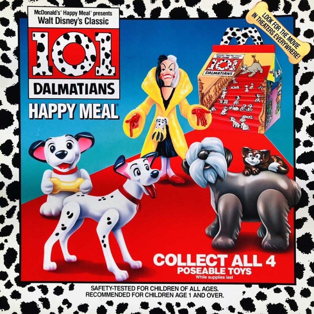 Promotional image for a McDonalds Happy Meal featuring four poseable toys from Disneys 101 Dalmatians. The background is black and white with a Dalmatian pattern, and includes characters like Cruella de Vil and various Dalmatians.