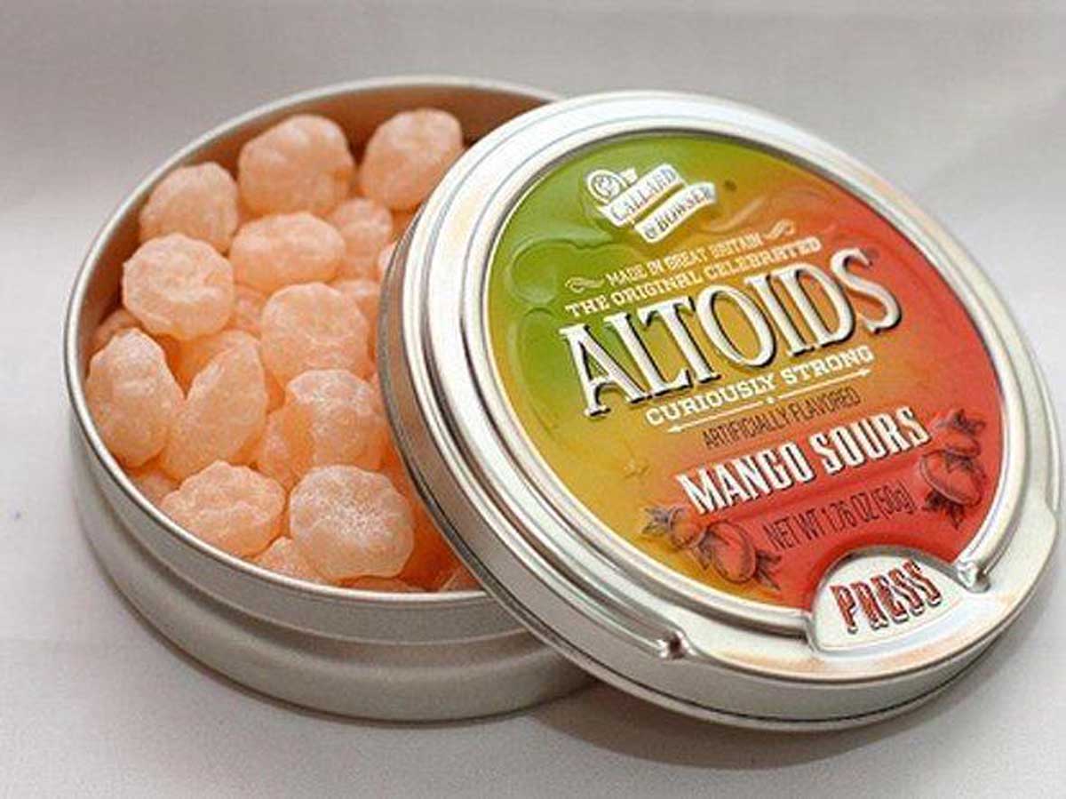 An open tin of Altoids Sours
