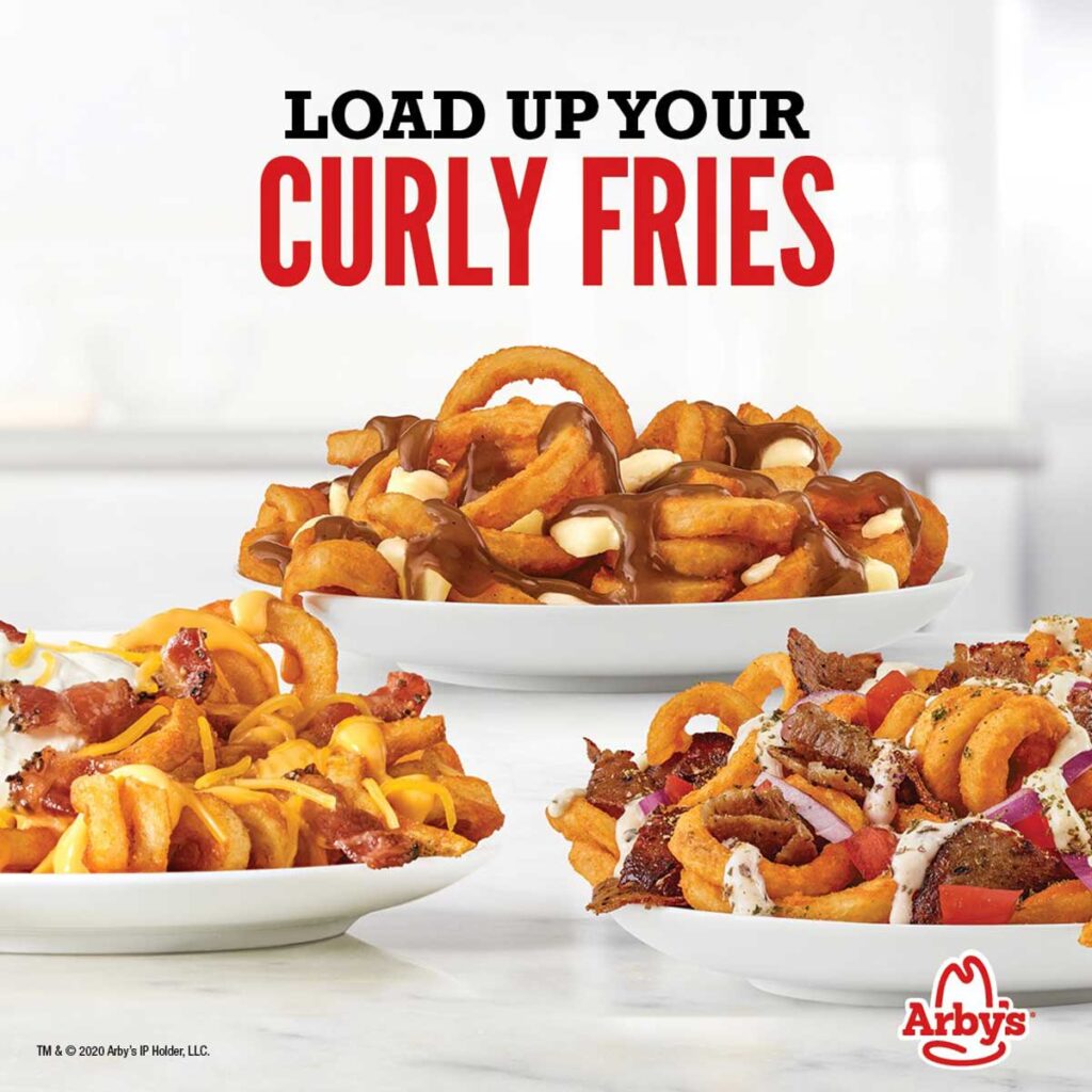 Three dishes of Arby's curly fries take the spotlight. One, adorned with gravy and cheese, another with cheese and bacon, and a third loaded with additional toppings reminiscent of discontinued fast food items. The text reads "Load Up Your Curly Fries" with the Arby's logo at the bottom.