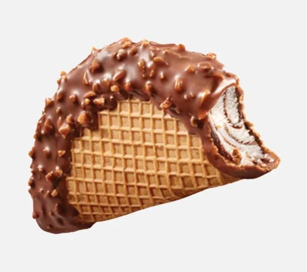 A chocolate-covered ice cream taco, reminiscent of discontinued Taco Bell menu items, boasts a waffle cone shell and a creamy vanilla-chocolate swirl filling. Its luscious chocolate coating is studded with small nut pieces, making it an indulgent treat even when partially eaten.