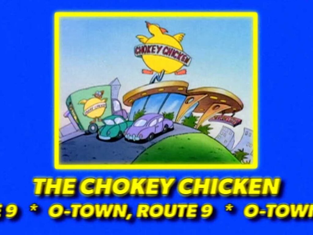 Illustration of a fictional restaurant called The Chokey Chicken on a hill. The building features a large chicken on the sign, with two cars parked outside. The text below reads O-Town, Route 9.