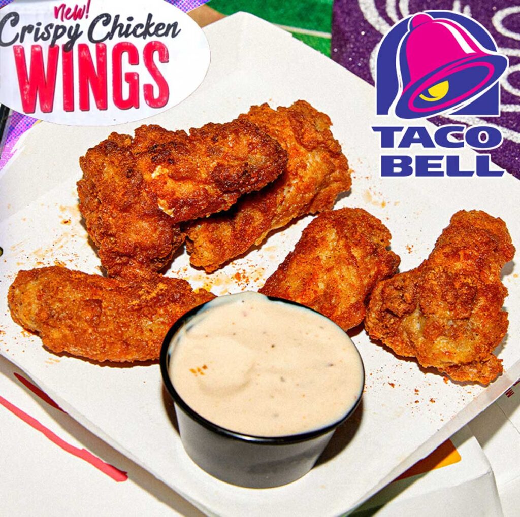 A plate of crispy chicken wings is served with a small cup of dipping sauce. The image, reminiscent of discontinued Taco Bell menu items, features Taco Bell and Crispy Chicken Wings branding in the corners.