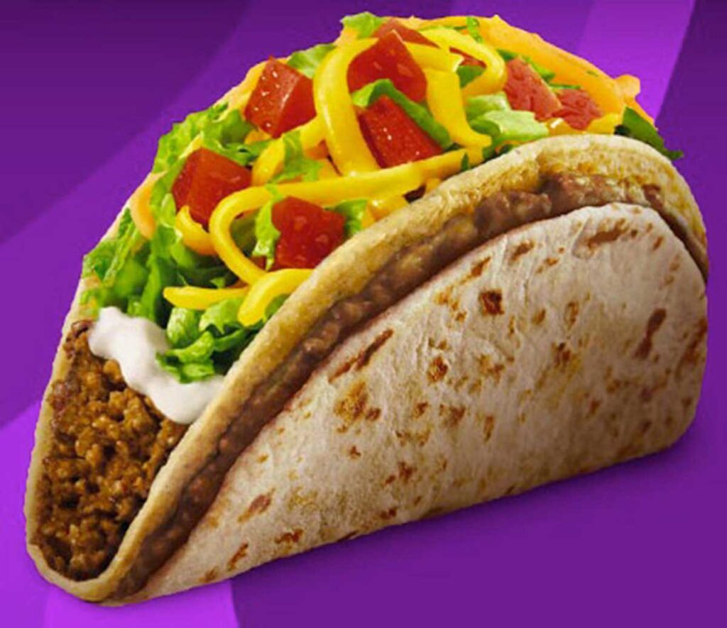 A taco reminiscent of discontinued Taco Bell menu items features a soft flour tortilla packed with ground beef, refried beans, shredded lettuce, diced tomatoes, cheddar cheese, and a dollop of sour cream, all set against a vibrant purple backdrop.