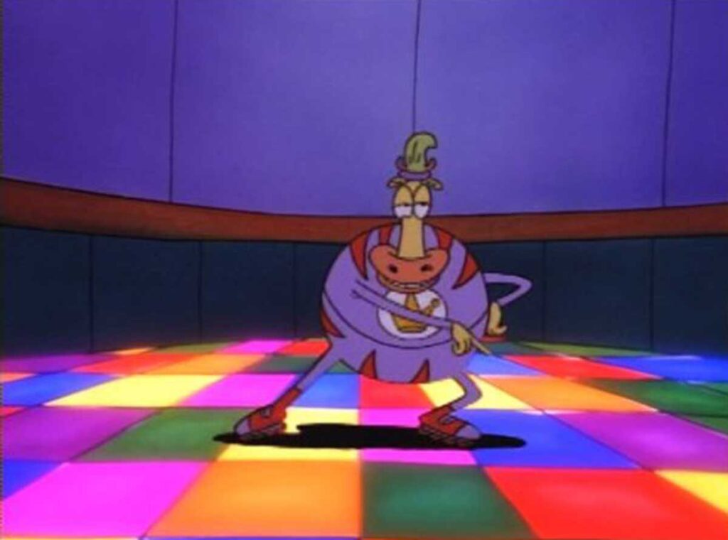 A cartoon cow wearing a colorful outfit and green hat dances confidently with folded arms on a vibrant, multicolored checkered dance floor. The background is a dark, curving wall, emphasizing the bright pattern on the floor.