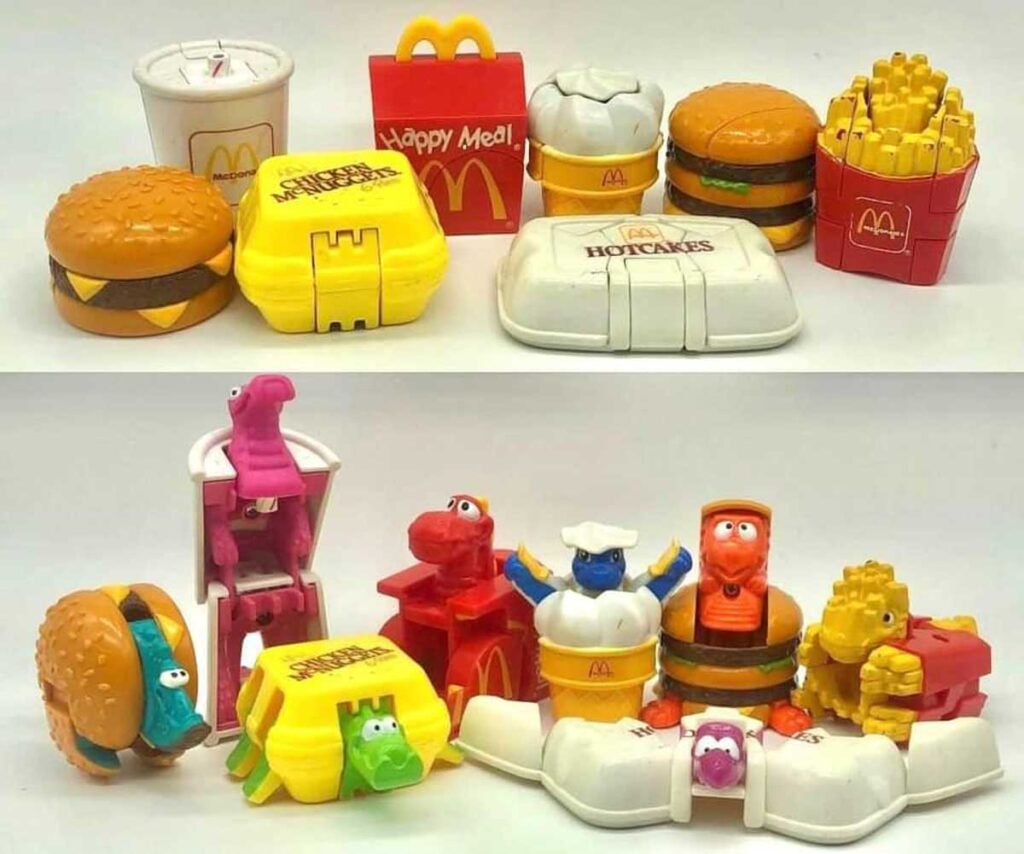 A collection of vintage McDonalds Happy Meal toys depicting hamburgers, fries, and other items transforming into cartoon characters and creatures. The toys are shown both closed and transformed.