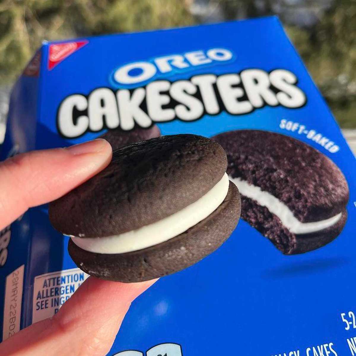 Photo of someone holding an Oreo Cakesters in front of a box of oreo cakesters