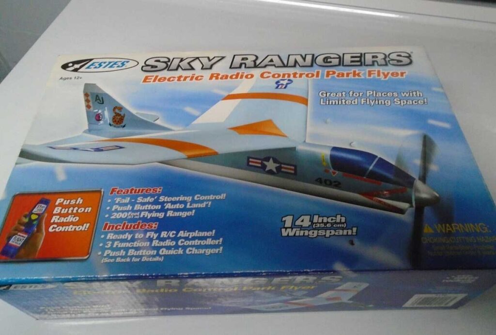 Box of an Estes Sky Rangers electric radio control park flyer. Features include: push button radio control, self-steering, full RC airplane, 14-inch wingspan. Designed for ages 10 and up, great for limited flying spaces.