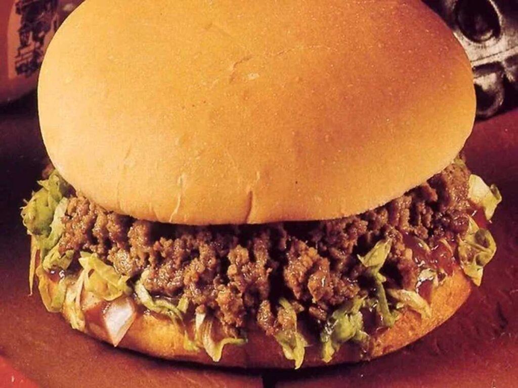 A nod to discontinued fast food items, this sandwich features a soft bun filled with cooked ground meat, shredded lettuce, and a tangy sauce.