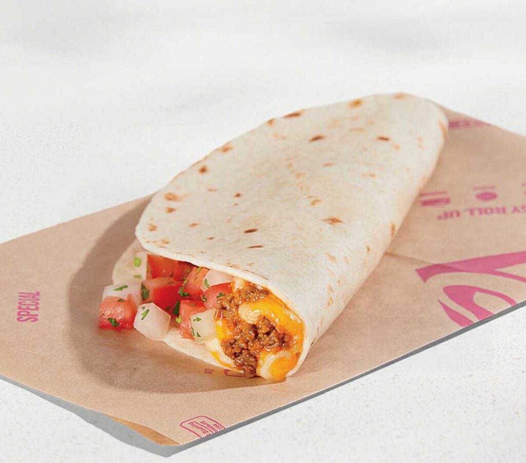 A flour tortilla wrap, reminiscent of beloved discontinued fast food items, is filled with seasoned ground beef, melted cheese, and diced tomatoes with herbs. It sits on a brown paper wrapper, partially folded to reveal its colorful fillings.