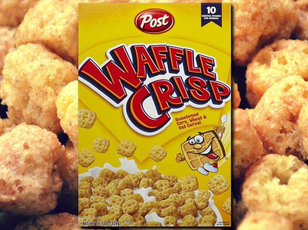 A box of Post Waffle Crisp cereal, a beloved discontinued snack from the 90s, features a cartoon waffle character against a background of sweetened corn, wheat, and oat cereal pieces.