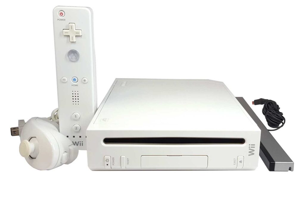 A white gaming console, renowned as one of the best-selling video game consoles, comes with a sensor bar, controller, and nunchuck attachment. The console includes a front disc slot and a controller with directional buttons and motion-sensing ability. A power cord is visible on the side.