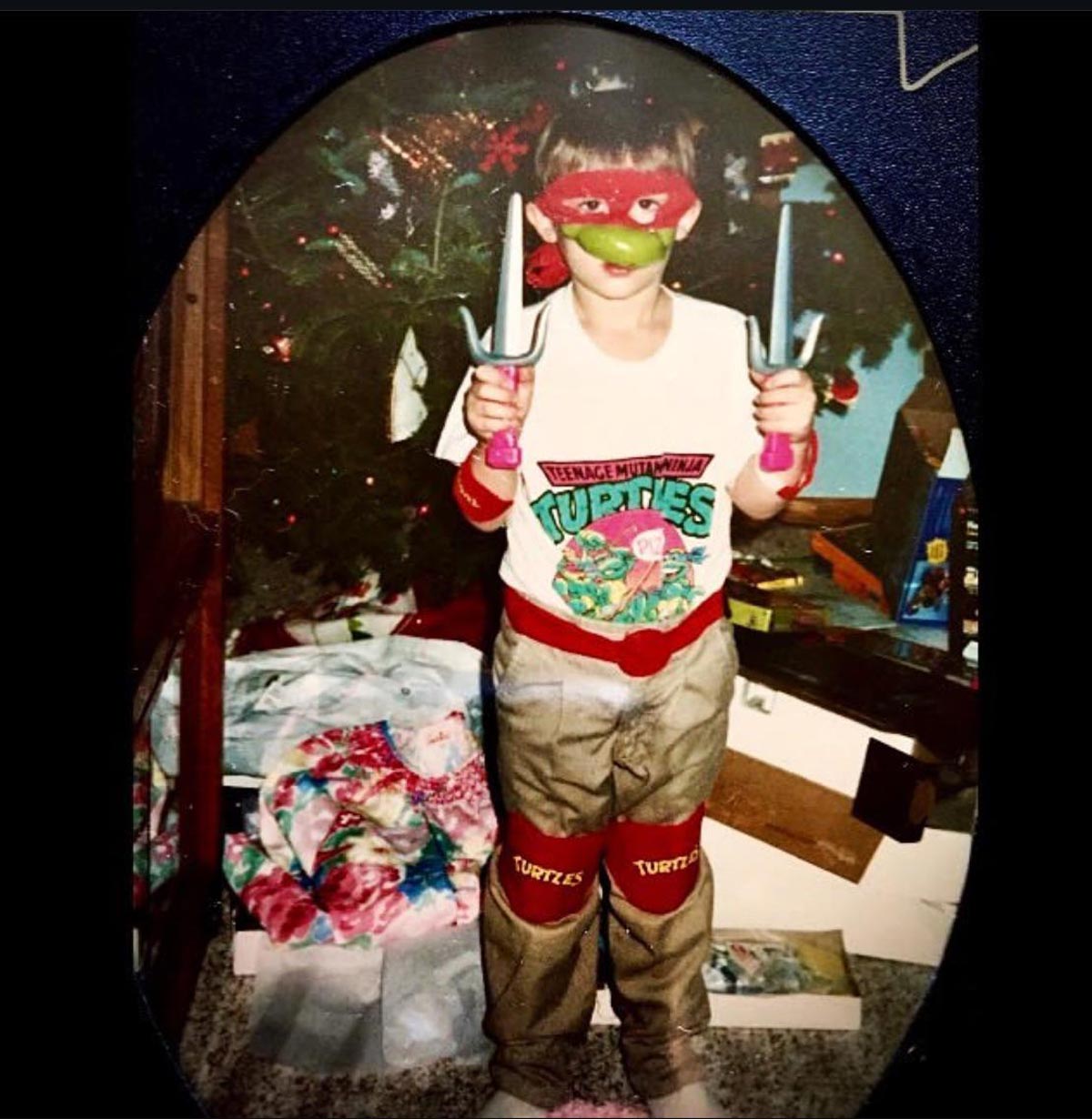 Kid on Christmas morning in head to toe Teenage Mutant Ninja Turtle gear