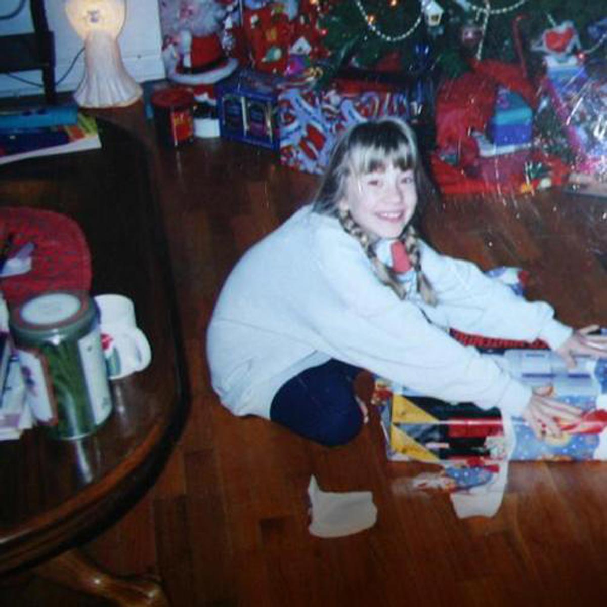 Kid unwrapping a Super Nintendo on Christmas morning.