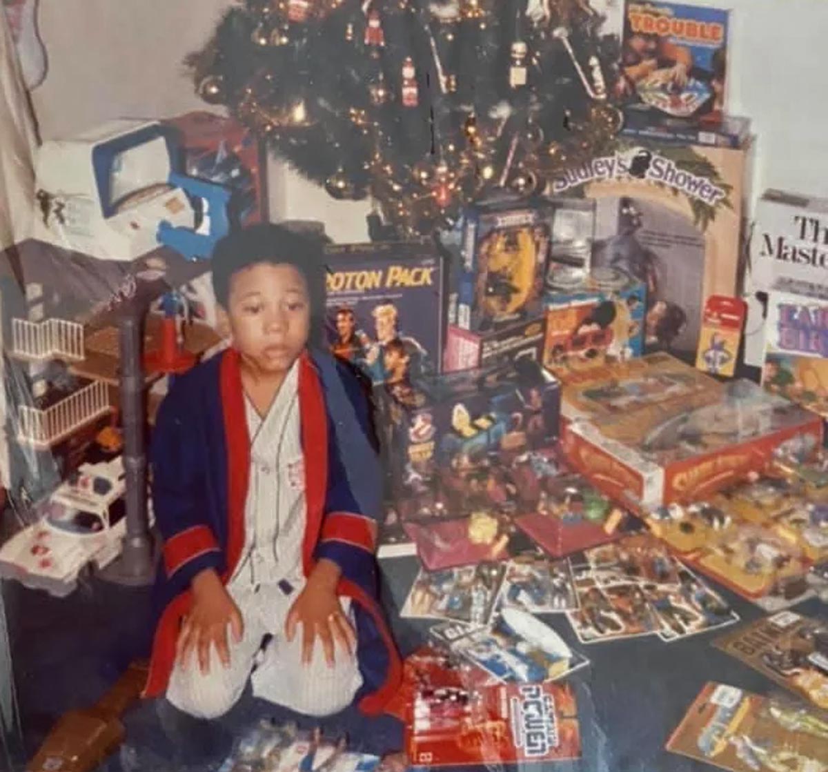 Kid looking overwhelmed on Christmas morning surrounded by presents