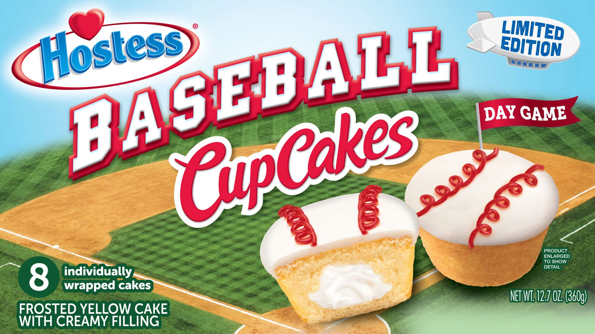 The image shows a package of Hostess Baseball CupCakes. The box features two cupcakes, decorated with white frosting and red icing resembling baseball stitches. The package highlights 8 individually wrapped cakes, frosted yellow cake with creamy filling.