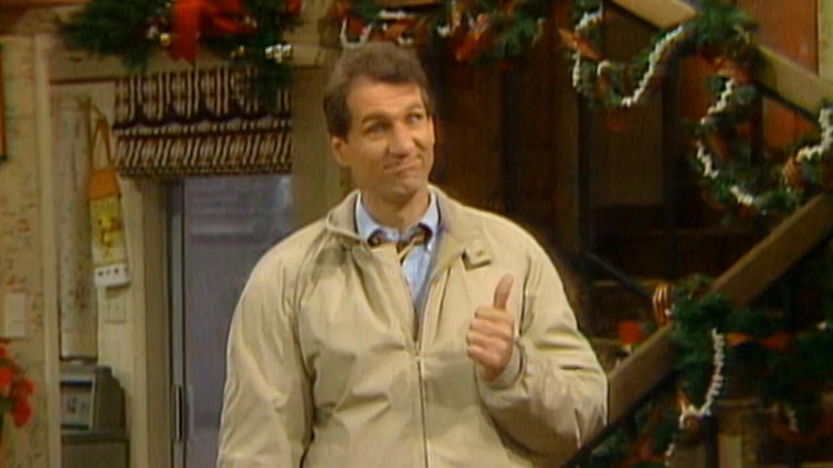 Married with Children - Al Bundy giving a thumbs up a smug smile in his home that is decorated for Christmas