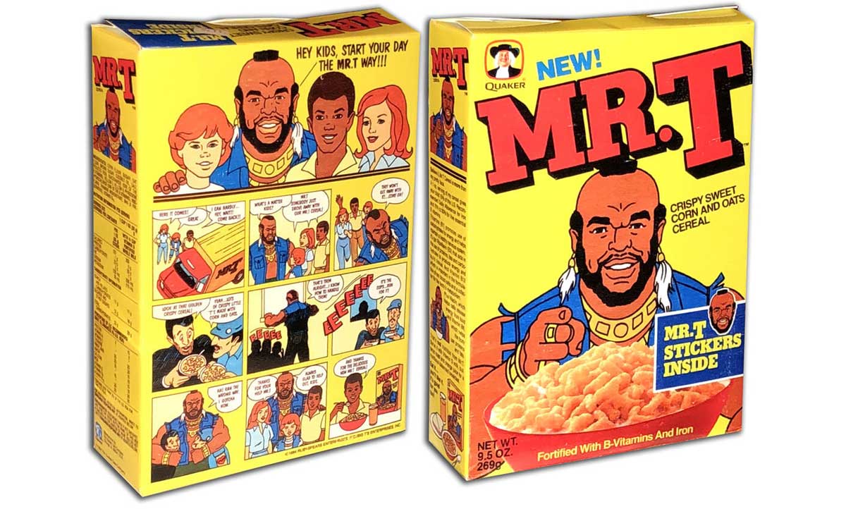 A box of  Mr. T cereal, with cartoon illustrations. The front shows Mr. T holding a bowl of cereal, while the back features a comic strip and additional graphics. The box advertises stickers inside and promotes vitamins and iron.