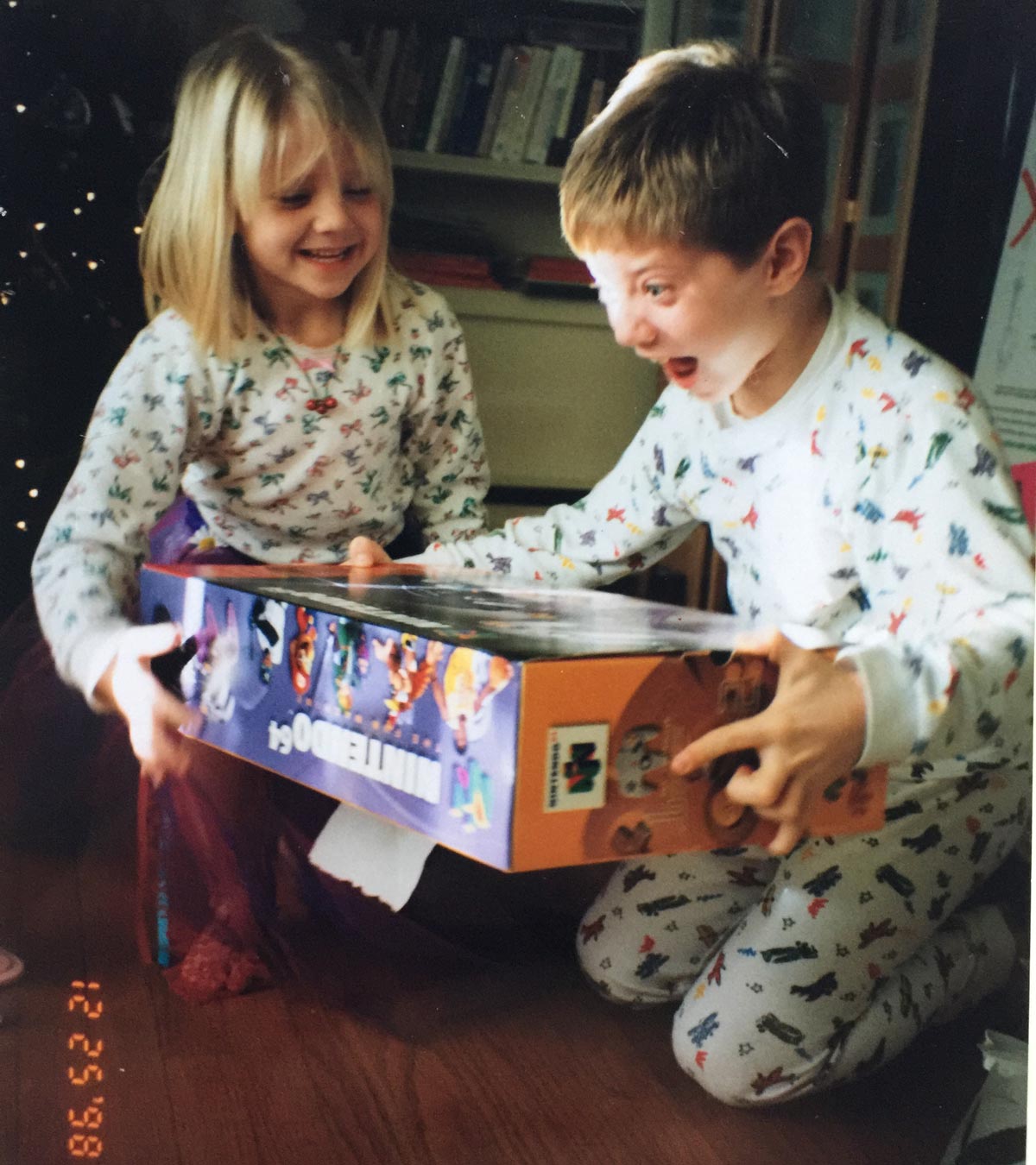 Two kids freaking out on Christmas morning in 1998 while unwrapping a Nintendo 64