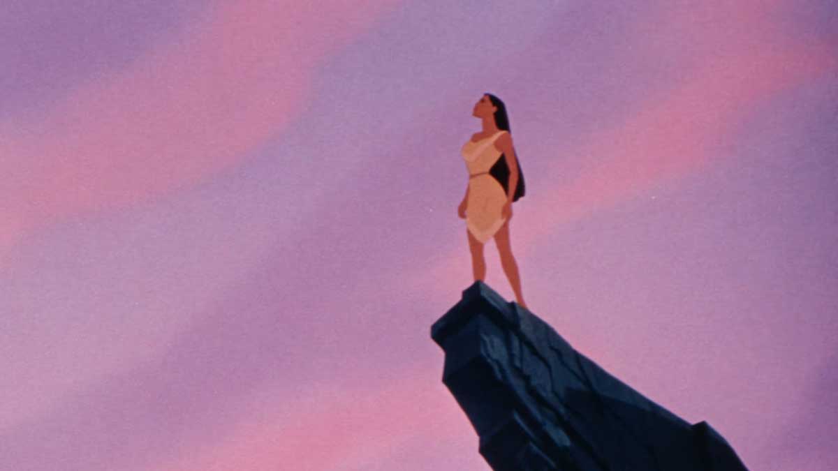 Pocahontas 1995 - Pocahontas stands confidently on a rocky cliff, gazing out at the horizon. The sky is a blend of soft pink and purple hues, creating a serene and majestic scene.