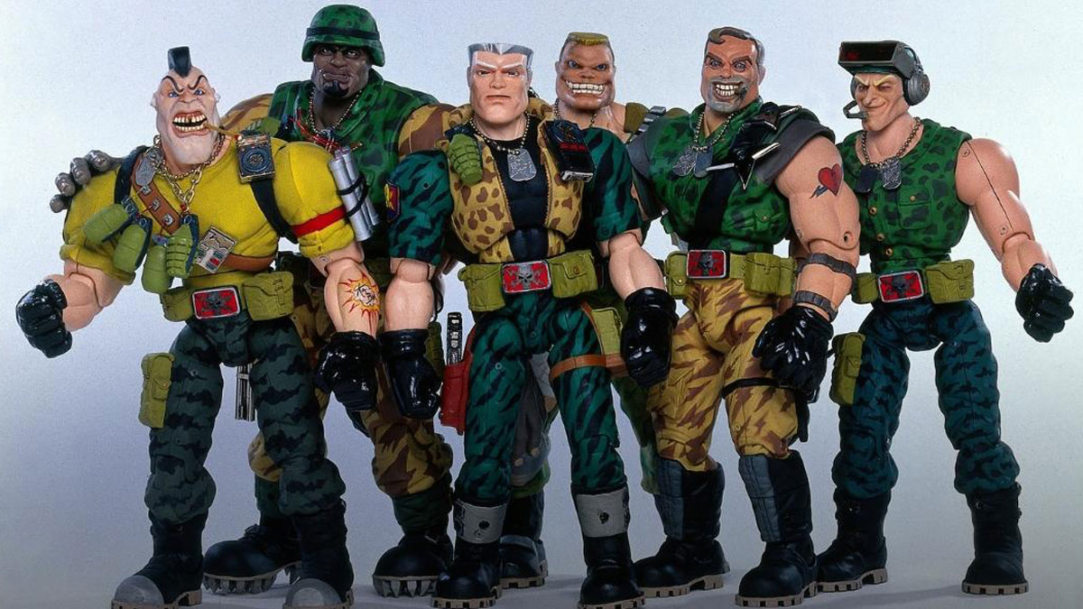 Action figures of six muscular characters dressed in military-style attire. They wear various camouflage patterns and accessories such as belts, gloves, and headgear, standing in a group with expressive facial features and poses.