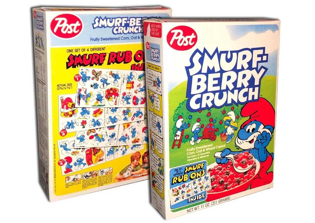 Front and back of a box of Post Smurf Berry Crunch, featuring colorful Smurf characters. The front shows a Smurf holding a bowl of this cherished treat, while the back displays a Smurf cartoon and cereal bowl. Includes “Smurf Rub Ons Inside” text on both boxes.