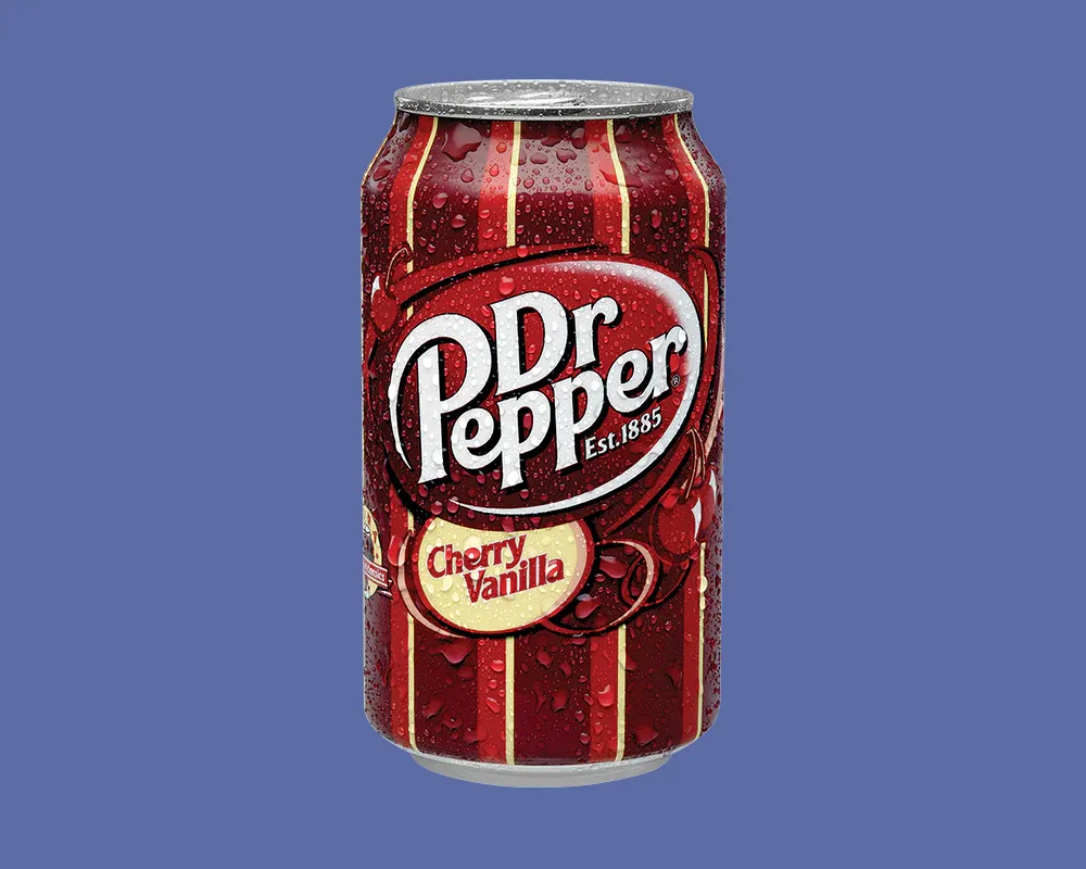 A can of Dr. Pepper Cherry Vanilla is centered on a blue background. The can is red with vertical stripes and features water droplets, suggesting its cold. The label includes the Dr. Pepper logo and Cherry Vanilla text.