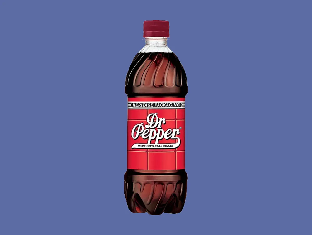 A bottle of Dr Pepper with heritage packaging and a red label is set against a blue background. The label reads Dr Pepper Made with Real Sugar. The bottle has a classic, contoured design with a red cap.