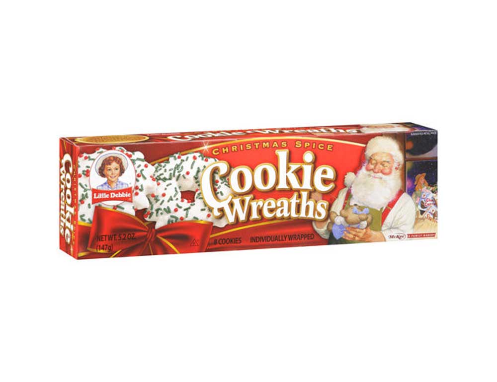 Box of Little Debbie Christmas Spice Cookie Wreaths featuring an illustration of Santa Claus holding a cookie, with festive red and gold packaging and a picture of the cookies decorated with green and red sprinkles.