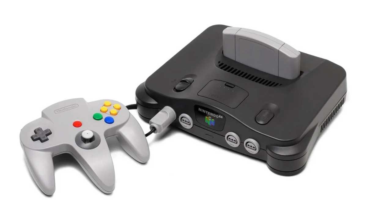 A gray Nintendo 64 gaming console with a matching controller plugged in, featuring colorful buttons, and a game cartridge inserted in the slot on top of the console.