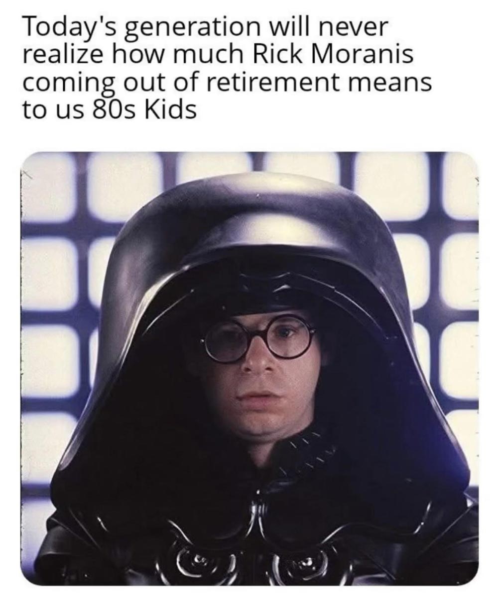 A person wearing round glasses and a large, shiny black helmet stands in front of a blue-lit grid background. Text above reads: “Todays generation will never realize how much Rick Moranis coming out of retirement means to us 80s kids.”.