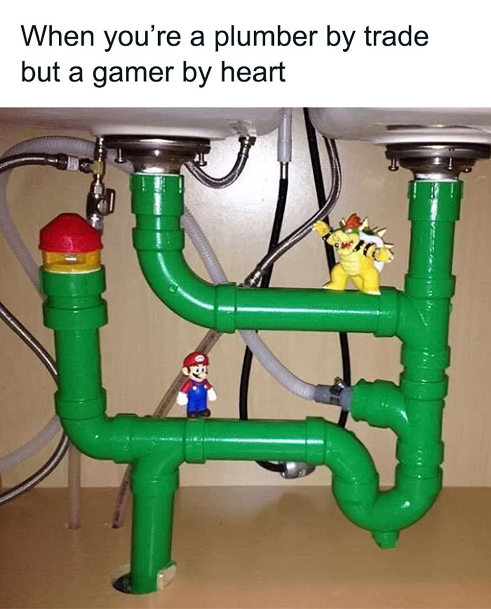 Green pipes under a sink are decorated to resemble Mario game elements, with toy figures of Mario and Bowser on them, and a red and yellow pipe cap resembling a Mario game object. Text above reads, When youre a plumber by trade but a gamer by heart.